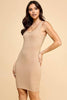 Woman wearing a beige sleeveless dress against a beige background
