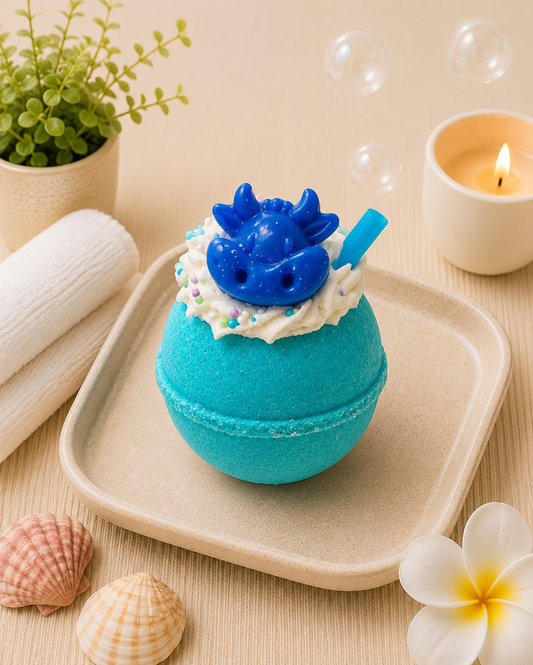 Blue bath bomb with a dinosaur design on a beige tray with bubbles and a candle in the background.