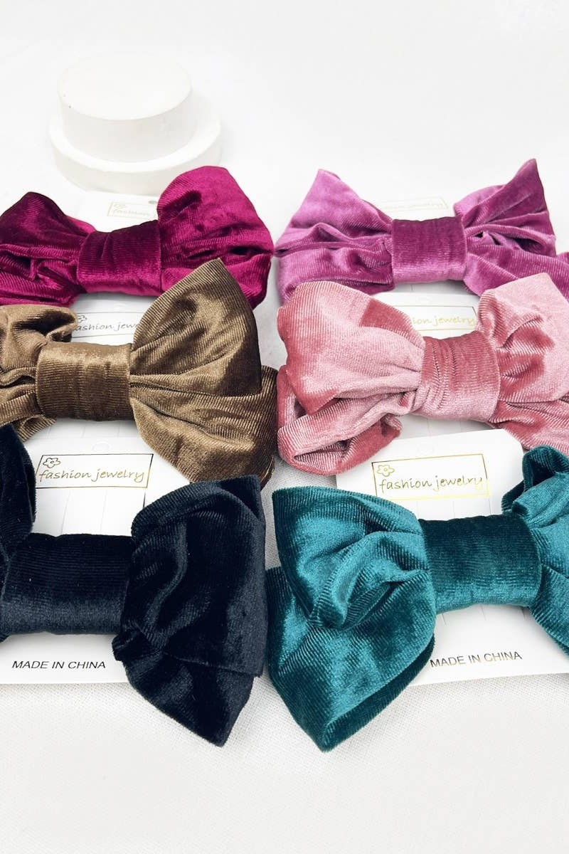 Set of colorful velvet hair bows on a white background