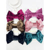 Set of colorful velvet hair bows on a white background