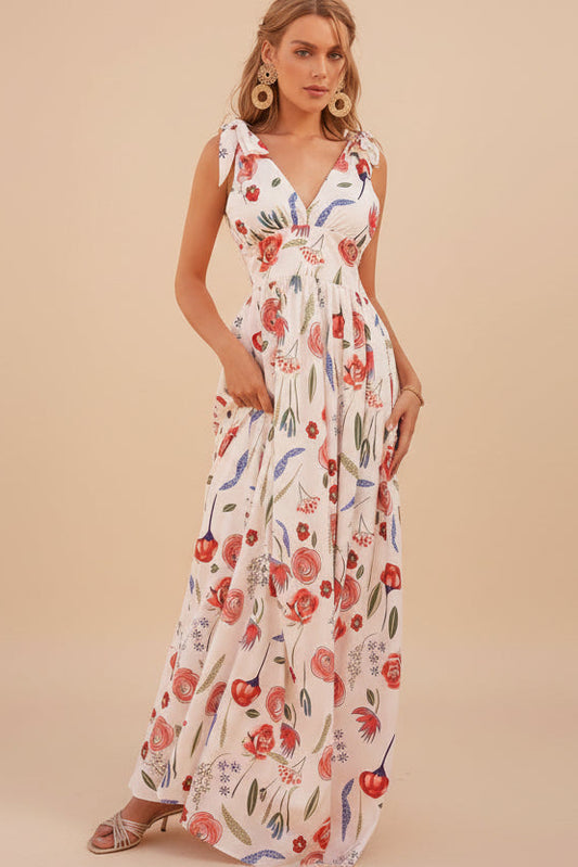 Woman wearing a floral dress against a white wall