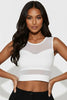 Woman wearing a white mesh top against a light background