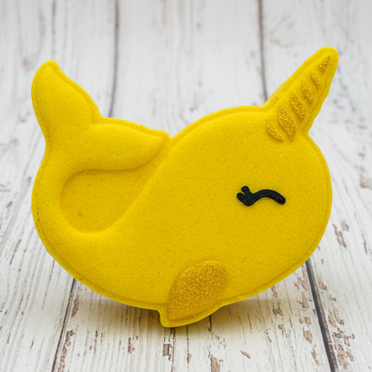 Yellow unicorn-shaped object on pebbles